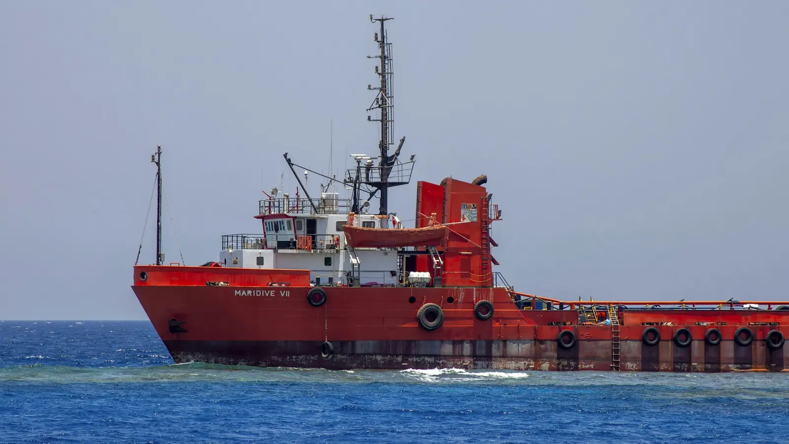 shipping on the Red Sea — A large red boat in the middle of the ocean